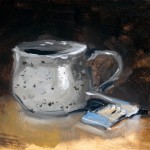 Still life oil painting of some matches and a mug